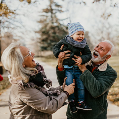 Grandparents with grandchild in Wrexham wooded area